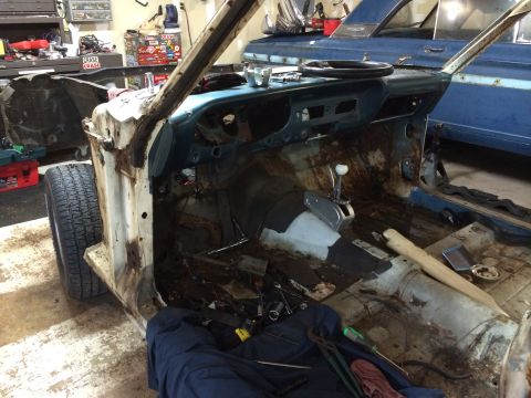1964 Ford Fairlane - The interior of a 1964 Ford Fairlane is shown stripped down, revealing its disassembled state and undergoing restoration.
