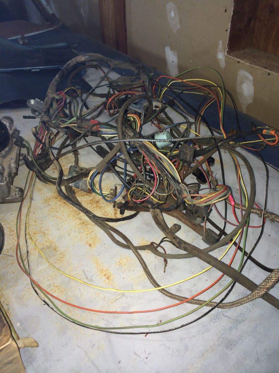 Tangled mess of old car wiring harness with many colored wires and connectors