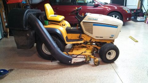 1994 Ford Bronco - A Cub Cadet riding mower with a bagger attachment is shown in a garage setting.