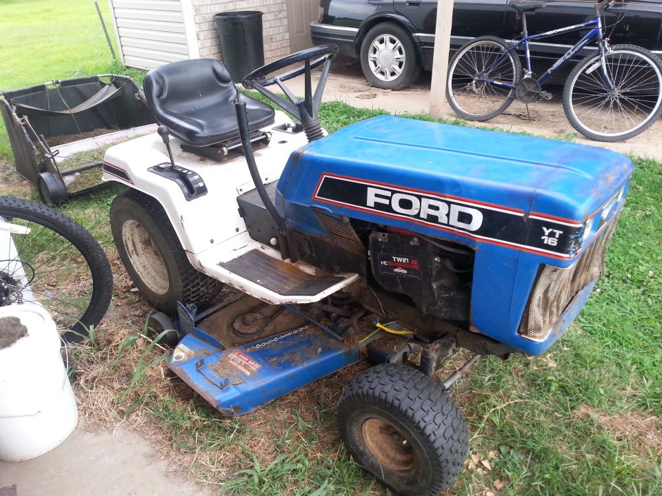 Blue Ford YT 16 lawn tractor with attached grass catcher