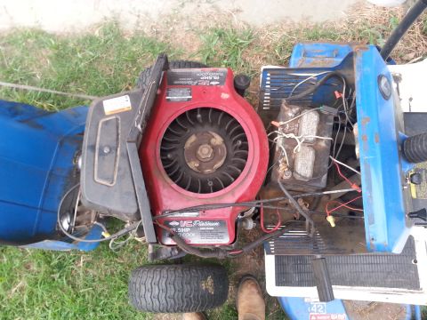 2002 Ford Expedition - Close-up view of a lawn mower's engine and battery, showing the '19.5HP TurboCool' label.
