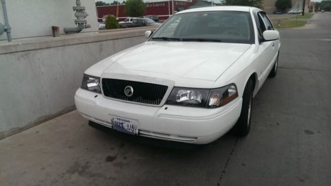 2000 Mercury Grand Marquis - Front 3/4 view of a white 2000 Mercury Grand Marquis parked on pavement.