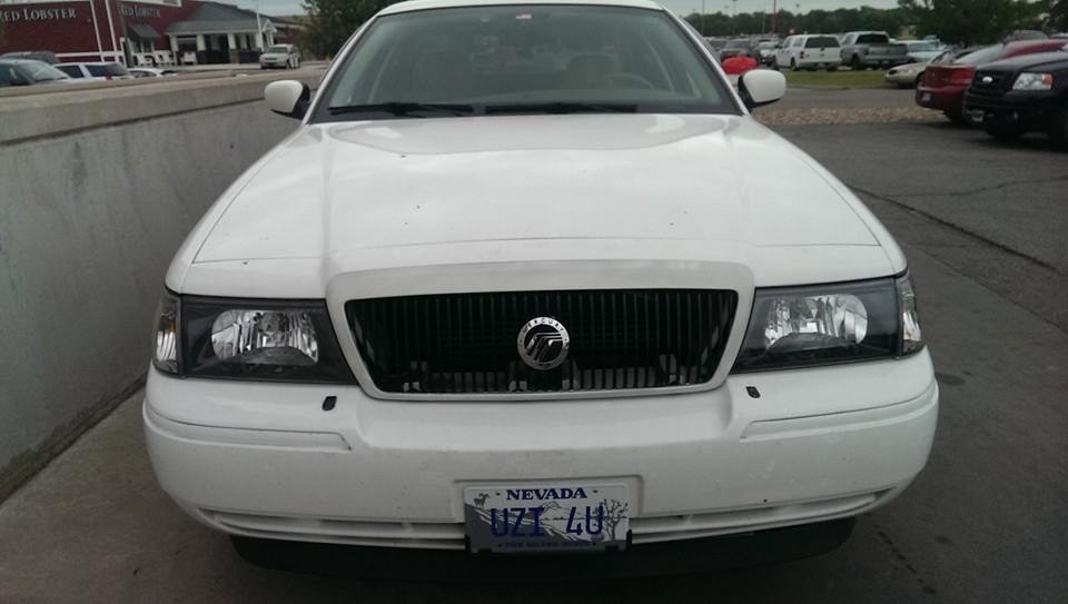 White 2000 Mercury Grand Marquis sedan, front view, with a black grille and Nevada license plate