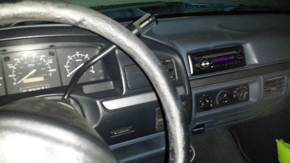 Dashboard with steering wheel, gauges, and aftermarket stereo