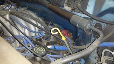 1996 Ford Bronco - Close-up view of an engine bay, showing various components including the oil cap and dipstick.
