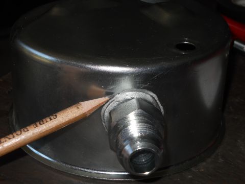 1992 Ford Bronco - A pencil is used to highlight a seal on a metal gauge with a threaded fitting.
