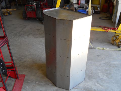1992 Ford Bronco - A hexagonal metal object is shown in a garage setting, with a website logo visible in the lower right corner.
