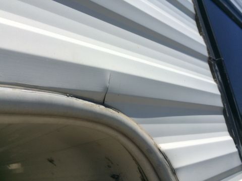 1986 Yugo GV - Visible crack on the exterior panel of an RV, located near the wheel well.