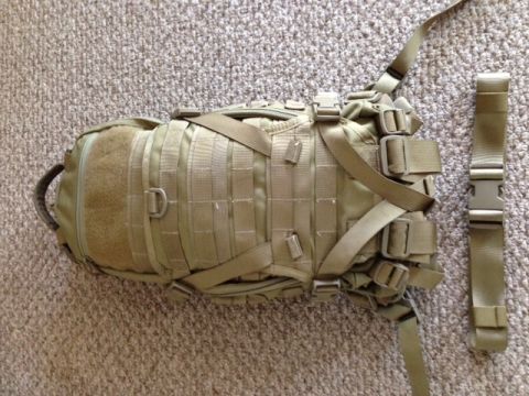 2005 Audi S4 - A tan tactical backpack with MOLLE webbing and straps is shown on a carpeted surface.