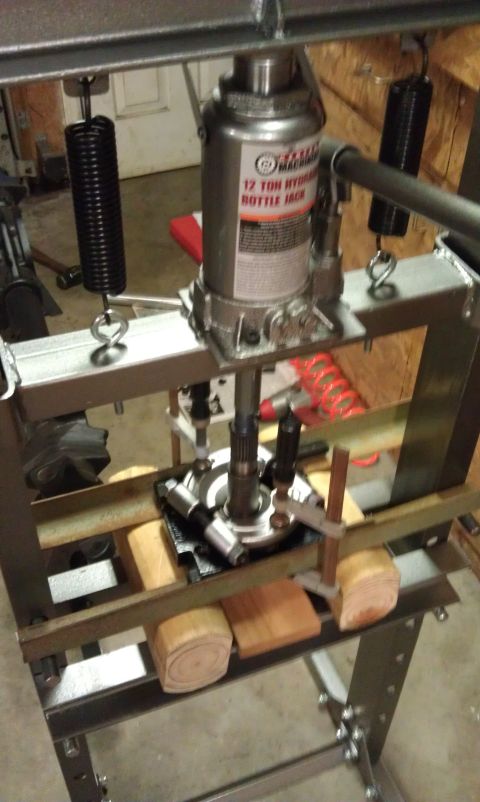 1990 Ford Bronco - Hydraulic bottle jack used with a press to work on a vehicle differential part.