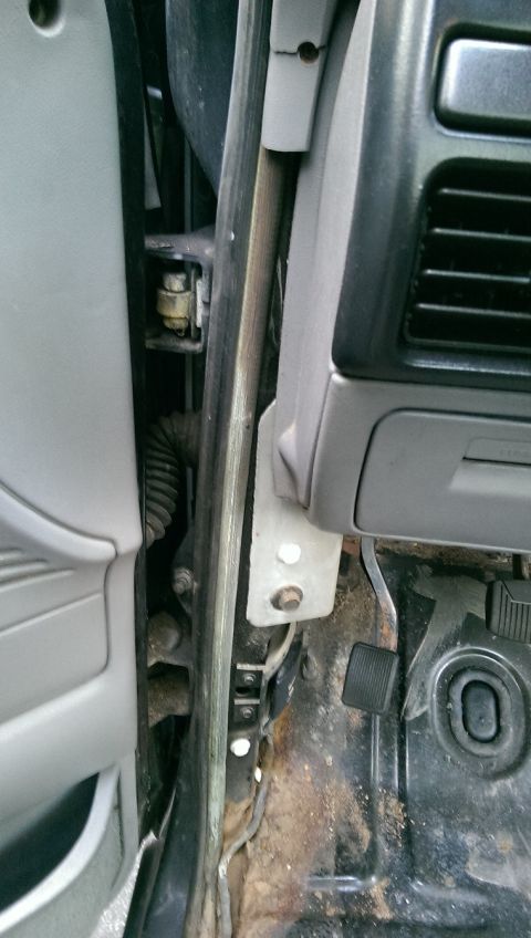 1996 Ford F-150 - Interior view of the door hinge and dashboard area of a 1996 Ford F-150.