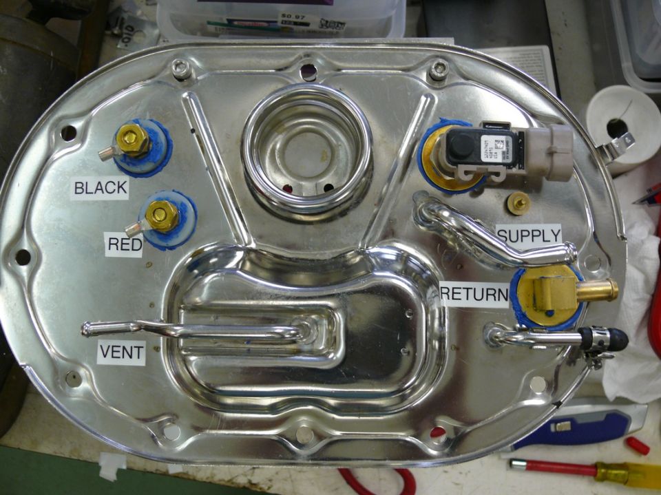 Fuel pump assembly with labeled ports for black, red, vent, supply, and return