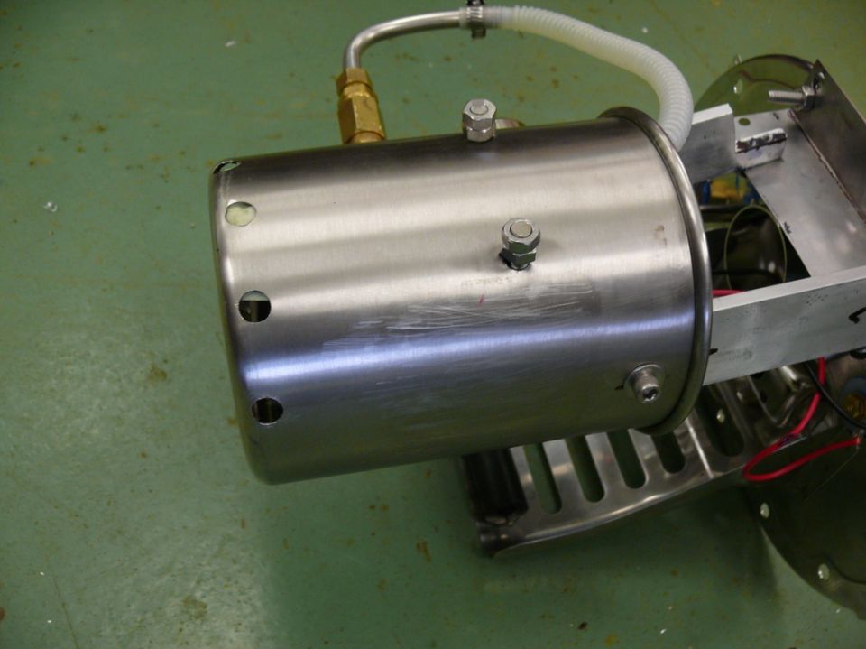 Stainless steel canister with brass fittings and white hose, mounted on metal frame