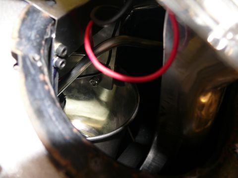 Close-up of engine bay components with red wire and Supermotors.net logo
