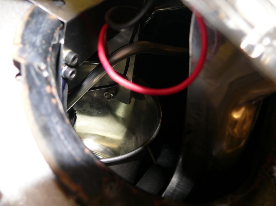 Close-up of engine bay components with red wire and Supermotors.net logo