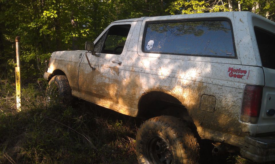 Mud-covered 1990 Ford Bronco side view