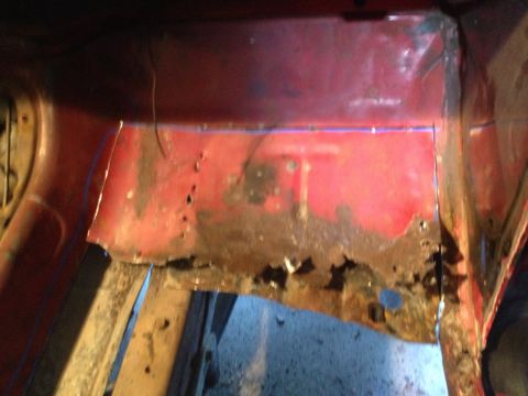 1978 Ford Bronco - The floor pan of a vehicle shows extensive rust damage and has been cut out for repair.
