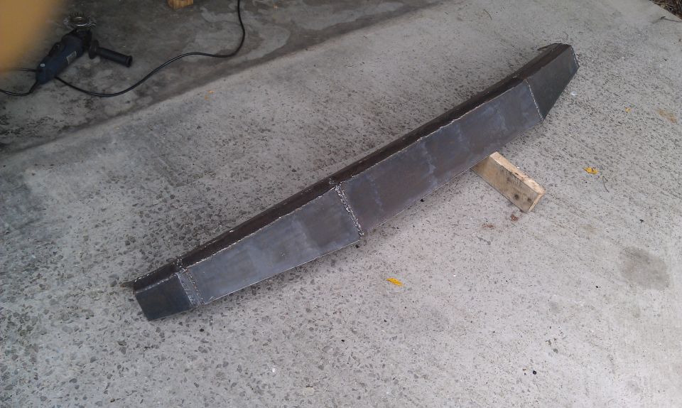 Metal bumper on concrete, angle grinder nearby