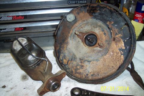 1978 Ford Bronco - A rusty brake booster and master cylinder are shown, likely for an older vehicle's braking system.