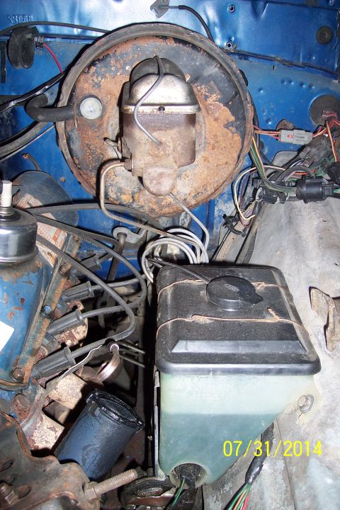 1978 Ford Bronco - Close-up of a vehicle's brake master cylinder and booster assembly, showing brake fluid level.