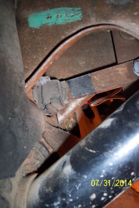 1978 Ford Bronco - A close-up view of a vehicle's brake system component, showing wear and tear.