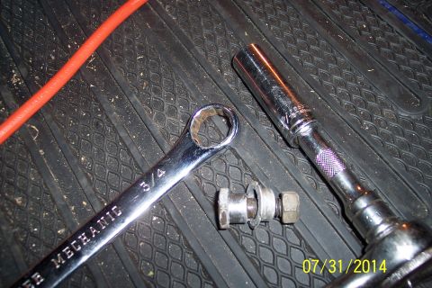 1978 Ford Bronco - Tools including a wrench and socket are laid out on a textured mat, possibly for vehicle maintenance.
