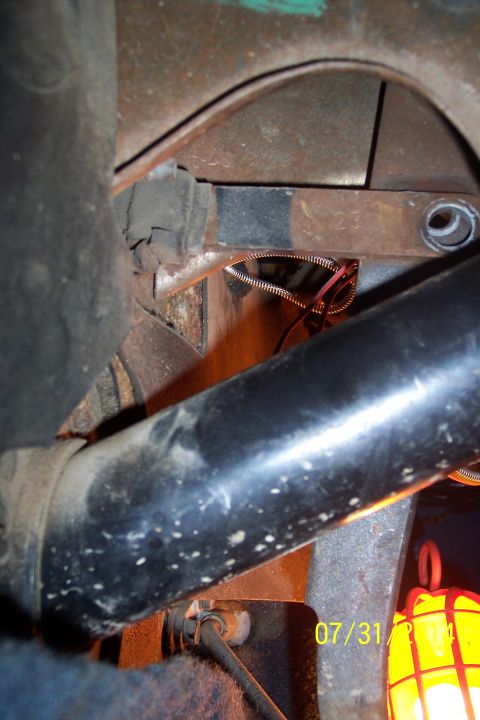 1978 Ford Bronco - A close-up view of a vehicle's undercarriage reveals brake components and a pair of sunglasses, with a date stamp of 07/31 visible.