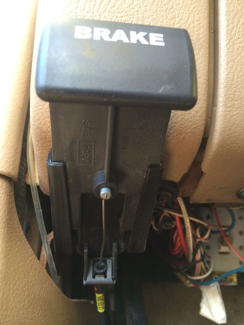 1997 Dodge 3500 - Interior view of a vehicle's parking brake mechanism, with visible wiring and plastic components.