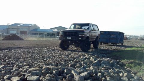 1992 Ford Bronco - 1992 Ford Bronco with aftermarket bumper and winch, parked on a rocky surface.