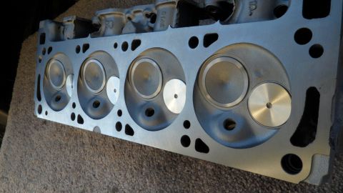 1972 Ford Ranchero - Close-up view of an engine cylinder head, showing the combustion chambers and stamped markings.