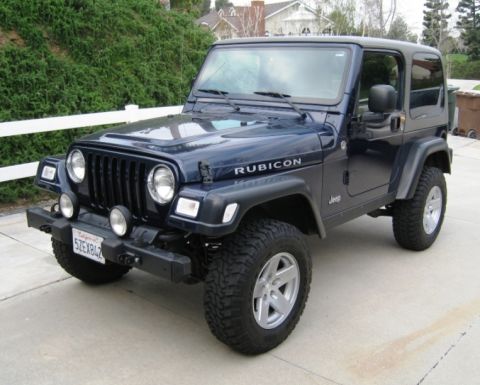 2000 Jeep Wrangler - This Jeep Wrangler Rubicon features a distinctive grille and body style, indicating a model year around 2003.