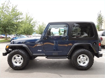 2000 Jeep Wrangler - Side profile of a two-door 2000 Jeep Wrangler with a black hardtop.