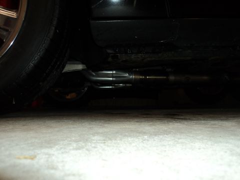 2004 Mercury Grand Marquis - Underside view of a car's exhaust system, showing dual pipes and a portion of the tire.