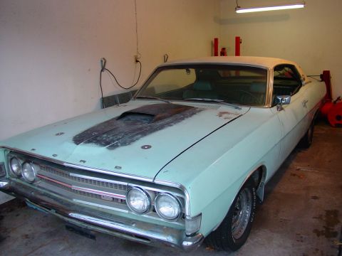 1969 Ford Torino - The front end of a 1969 Ford Torino GT shows its distinctive grille and hood scoop.