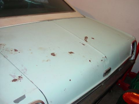 1969 Ford Torino - The rear of a 1969 Ford Torino shows signs of wear and tear with visible rust patches on the trunk lid.
