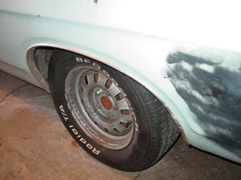 1969 Ford Torino - Close-up of the rear wheel well and tire on a 1969 Ford Torino, showing a primer patch on the fender.