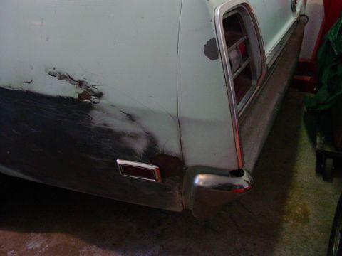 1969 Ford Torino - The rear of a 1969 Ford Torino shows significant body damage and primer.