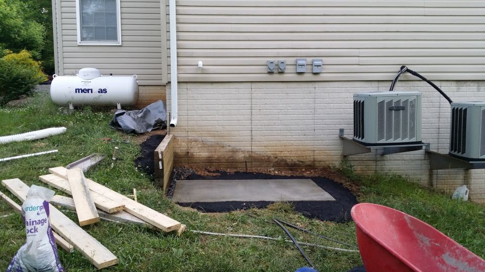 Propane tank labeled 'Amerigas' and two outdoor air conditioning units next to a house exterior wall