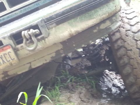 1996 Ford Bronco - This 1996 Ford Bronco is stuck in the mud, showing its front bumper and tire.