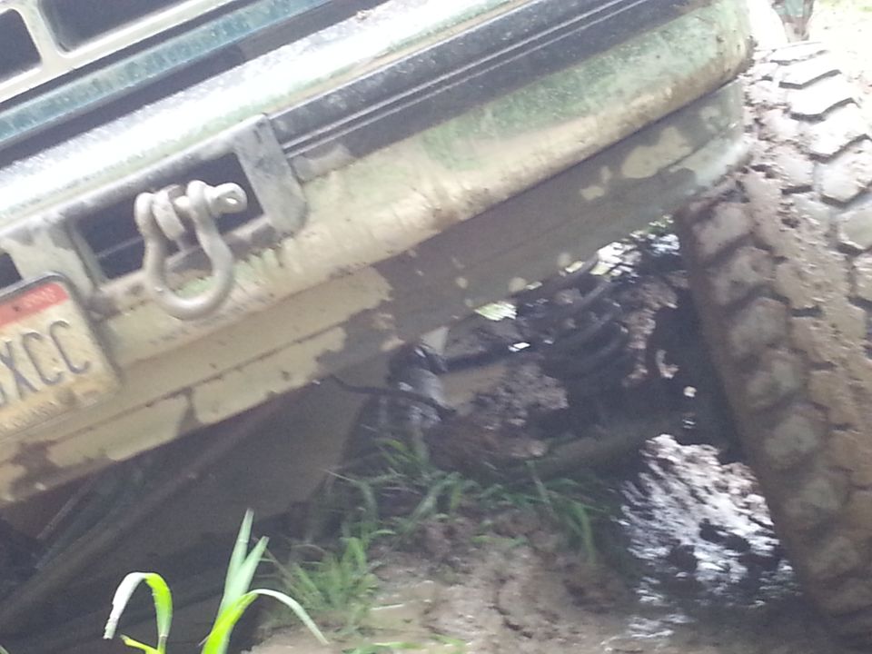1996 Ford Bronco front bumper and tire stuck in mud