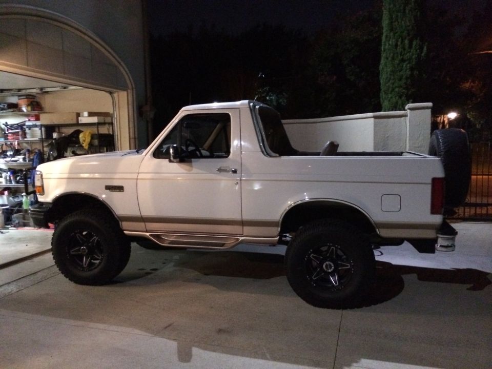 White 1996 Ford Bronco with removable top, side view