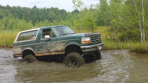 1996 Ford Bronco - This 1996 Ford Bronco is navigating through a muddy off-road trail.