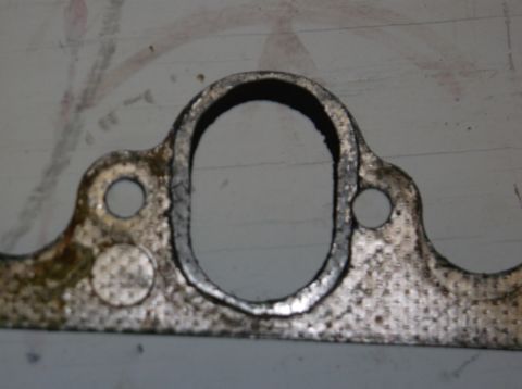 1979 Ford Ranchero - Close-up of an exhaust manifold gasket, showing its shape and mounting holes.