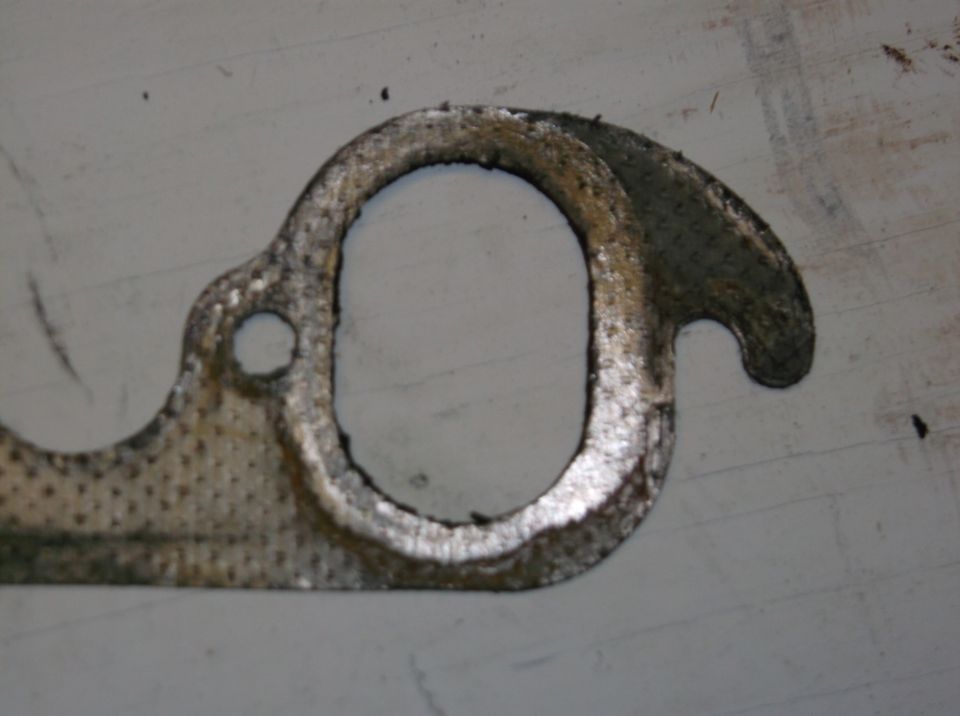 Exhaust manifold gasket with two large openings and one small bolt hole