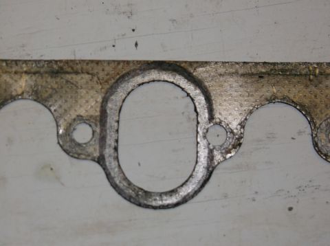 1979 Ford Ranchero - Close-up of a used exhaust manifold gasket, showing wear and tear.