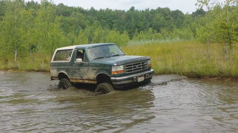 1996 Ford Bronco - This 1996 Ford Bronco navigates through a muddy, watery terrain.