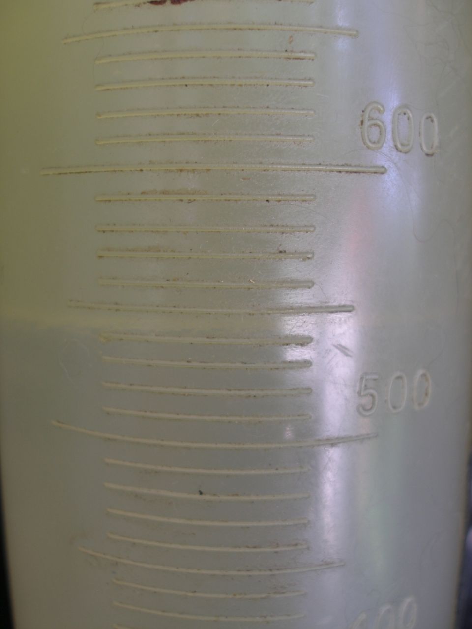 Close-up of a plastic graduated cylinder with markings for 500 and 600 milliliters