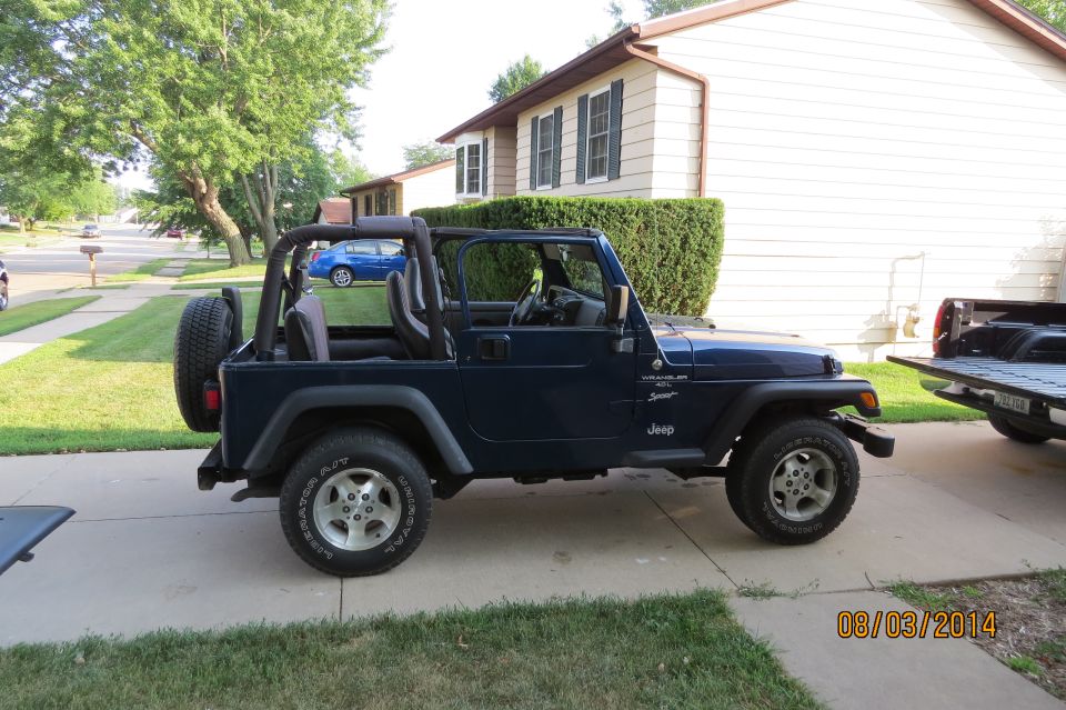 Dark blue 2000 Jeep Wrangler Sport parked on driveway