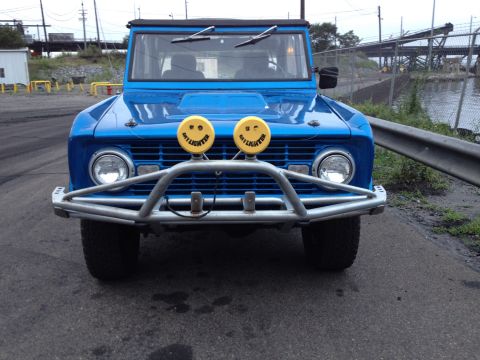 1974 Ford Bronco - This blue 1974 Ford Bronco features custom smiley face headlights and a robust brush guard.
