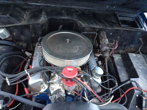 1974 Ford Bronco - Engine bay detail of a Ford V8 with an aftermarket air cleaner and visible wiring.